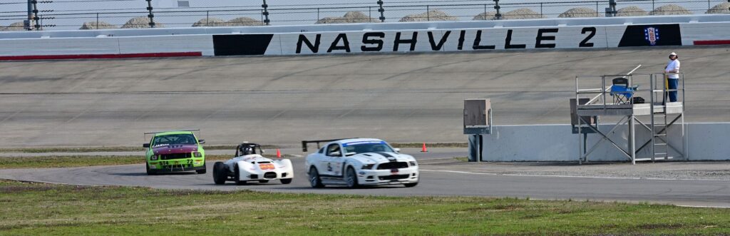 The Thunder Roadster racing some expensive American Iron equipment into the infield.