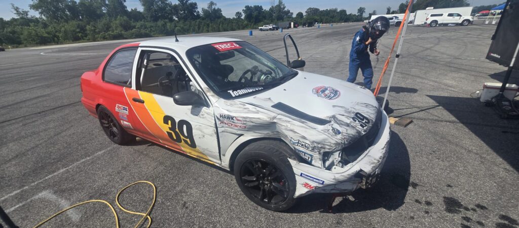 Bruce exiting the Toyota Tercel racecar after finding the tire wall on the hairpin exit.